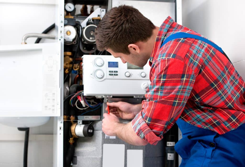 Technician servicing the gas boiler for hot water and heating