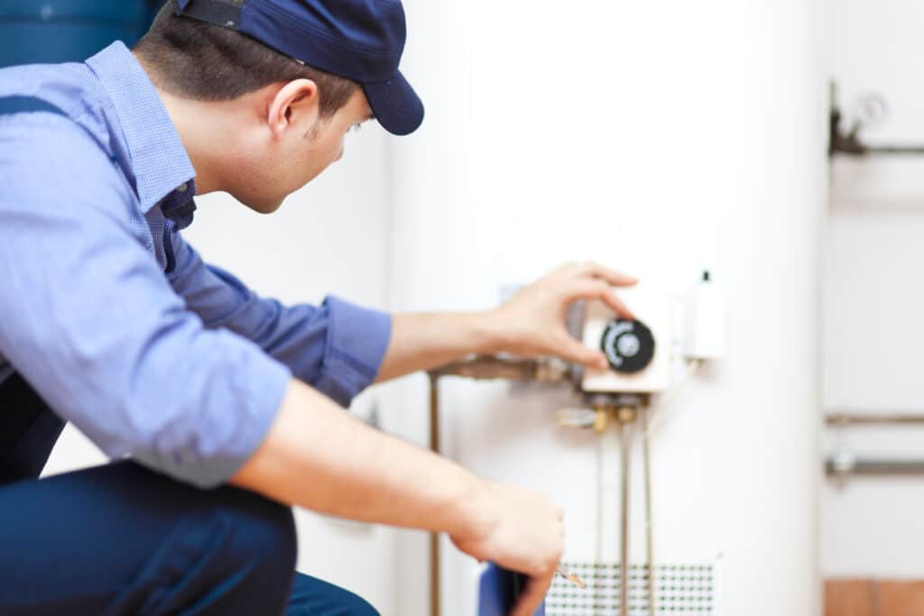 technician repairing hot-water heater