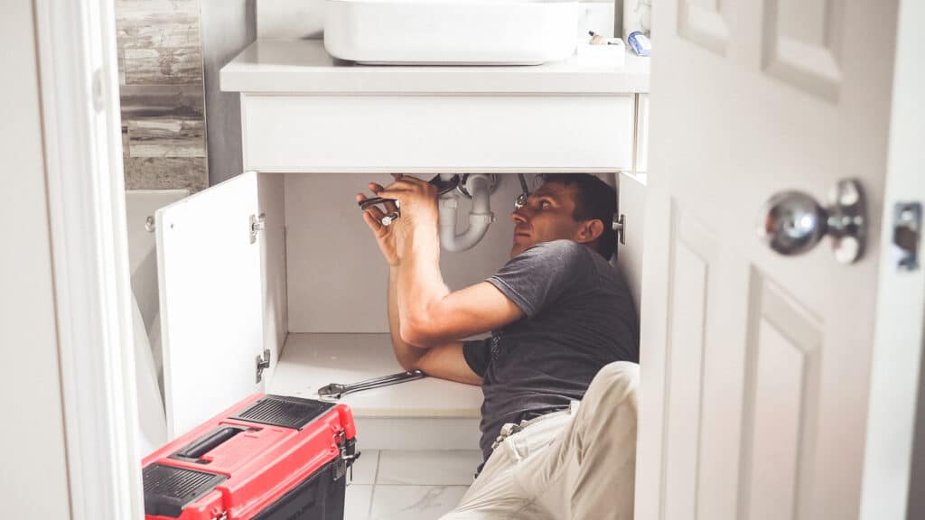 Plumber With Tools In the bathroom