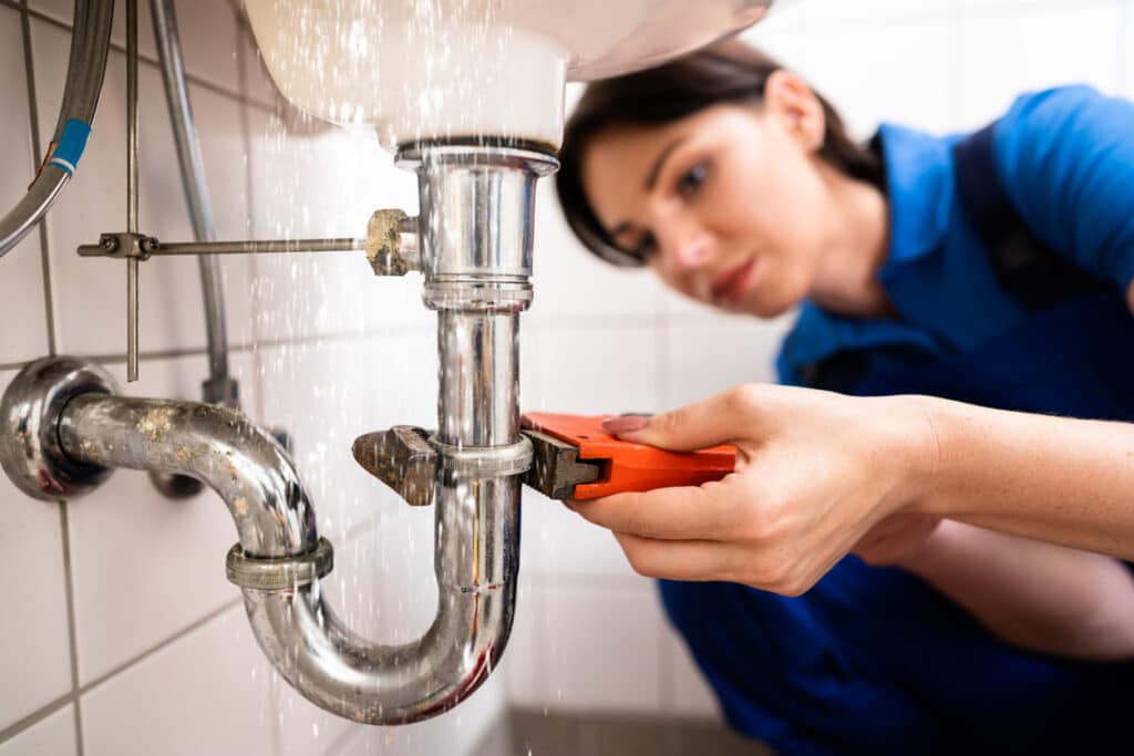 Plumber Repairing Sink Pipe