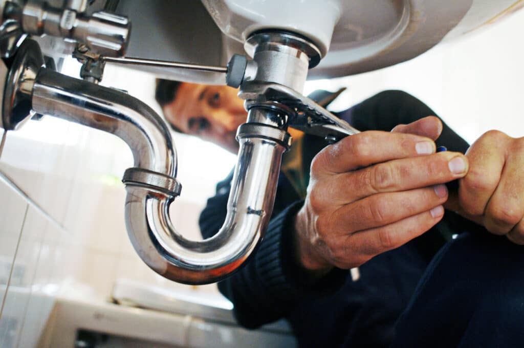 plumber repairing sink