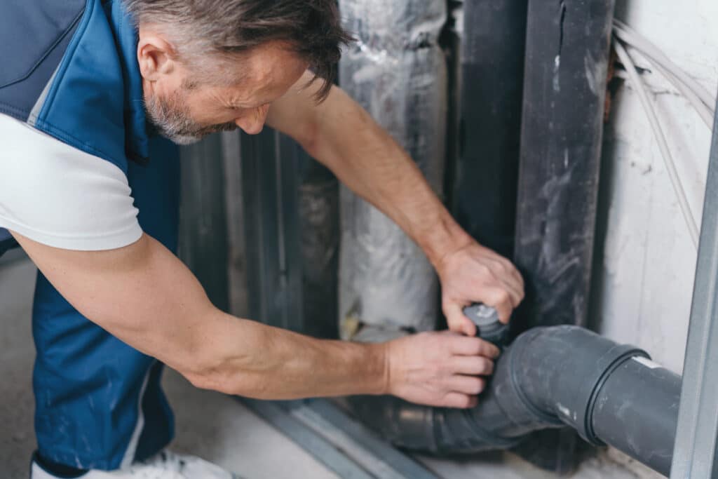 Handyman checking a plumbing connection